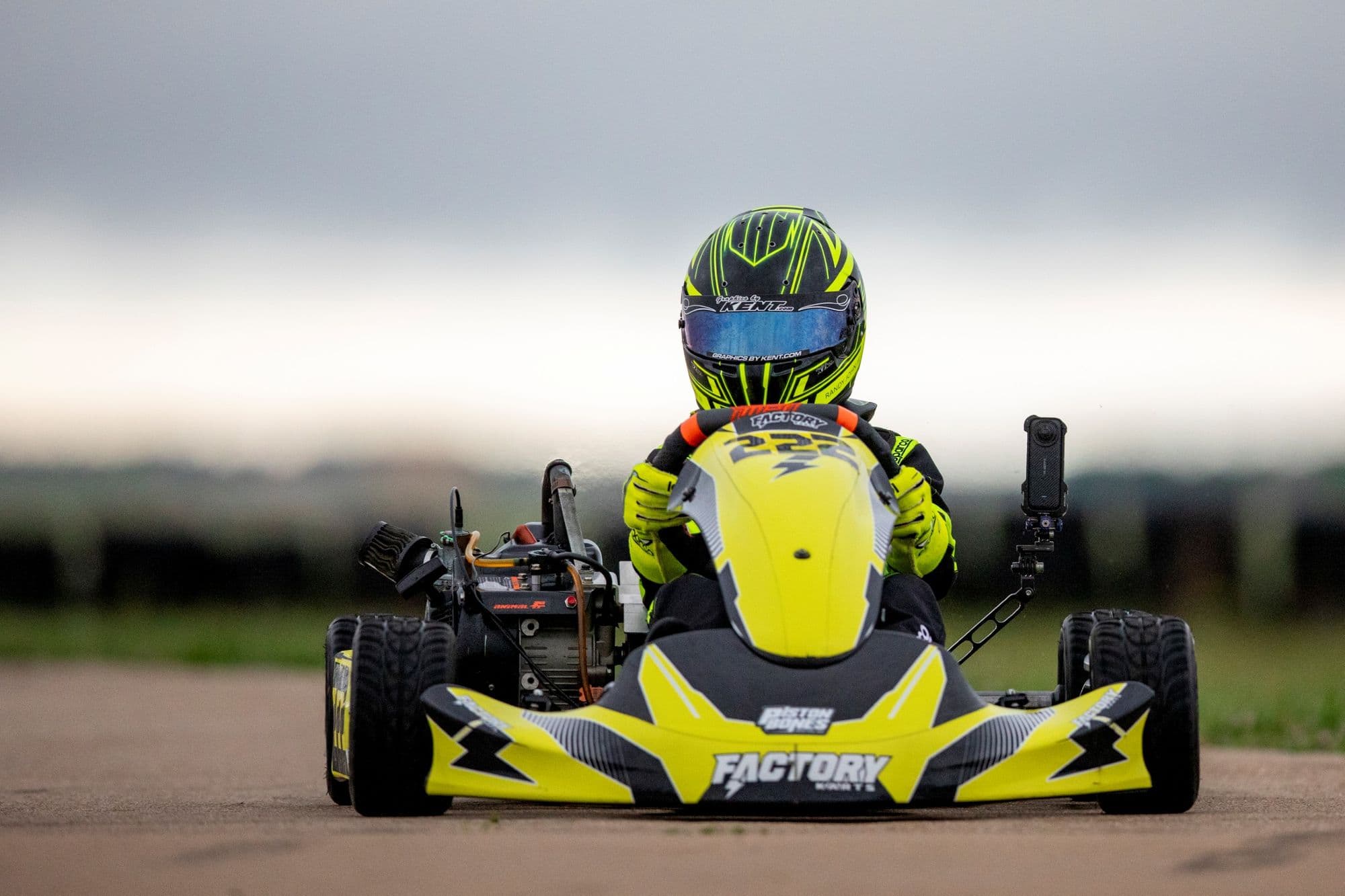 A yellow and black kart comes head-on through a corner at KartMoto.