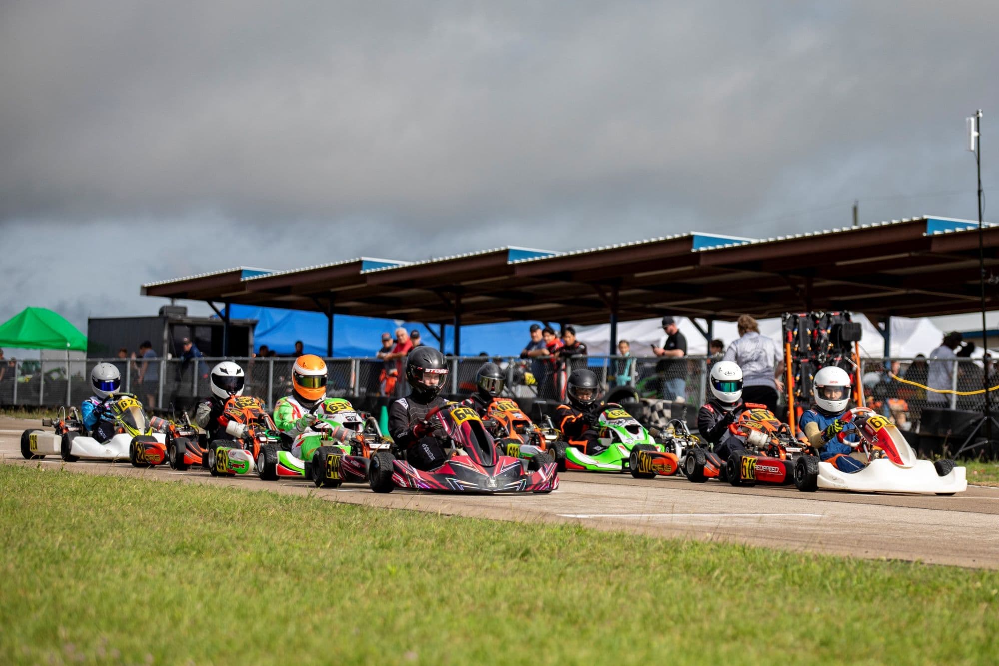 A wide view of the grid waiting under the pavilion at KartMoto.