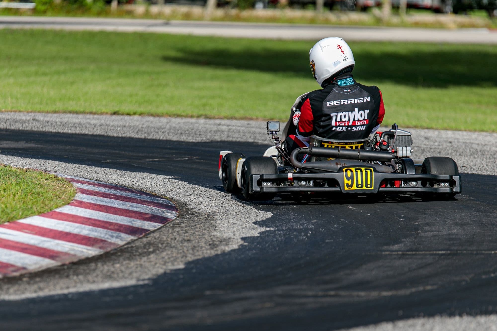 A kart rounds a curbed corner at GCKI Katy.