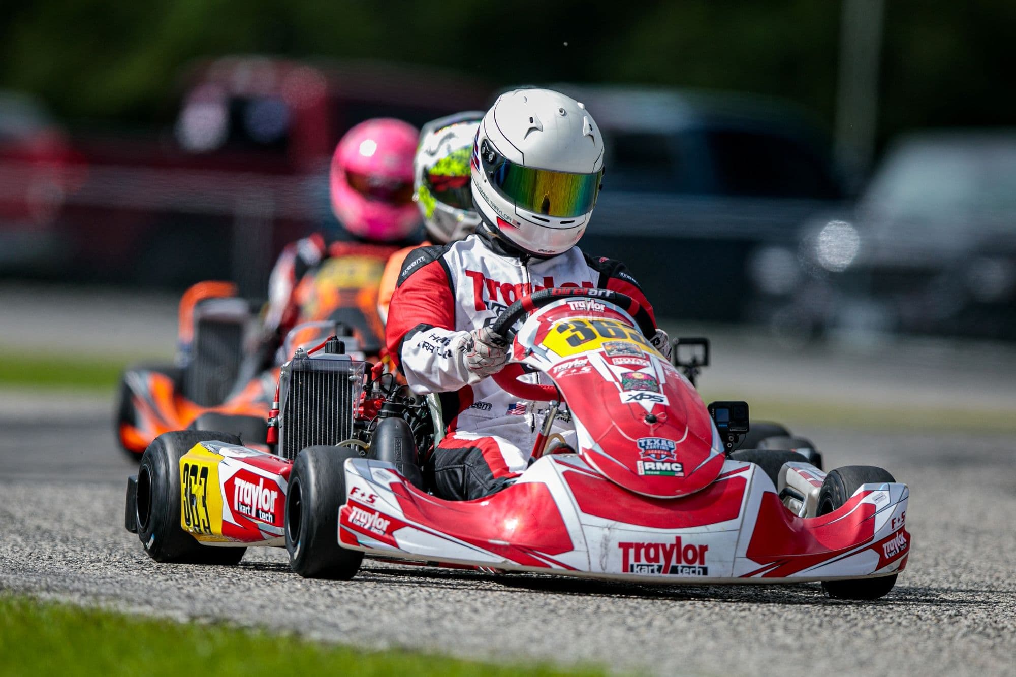 Two red karts battling head-on at GCKI Katy.