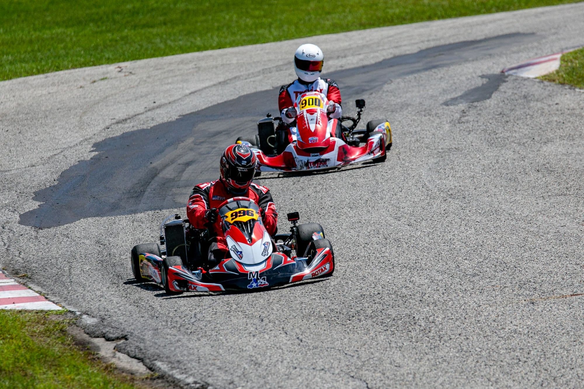 Two karts diving through a hairpin at GCKI Katy, seen from above.