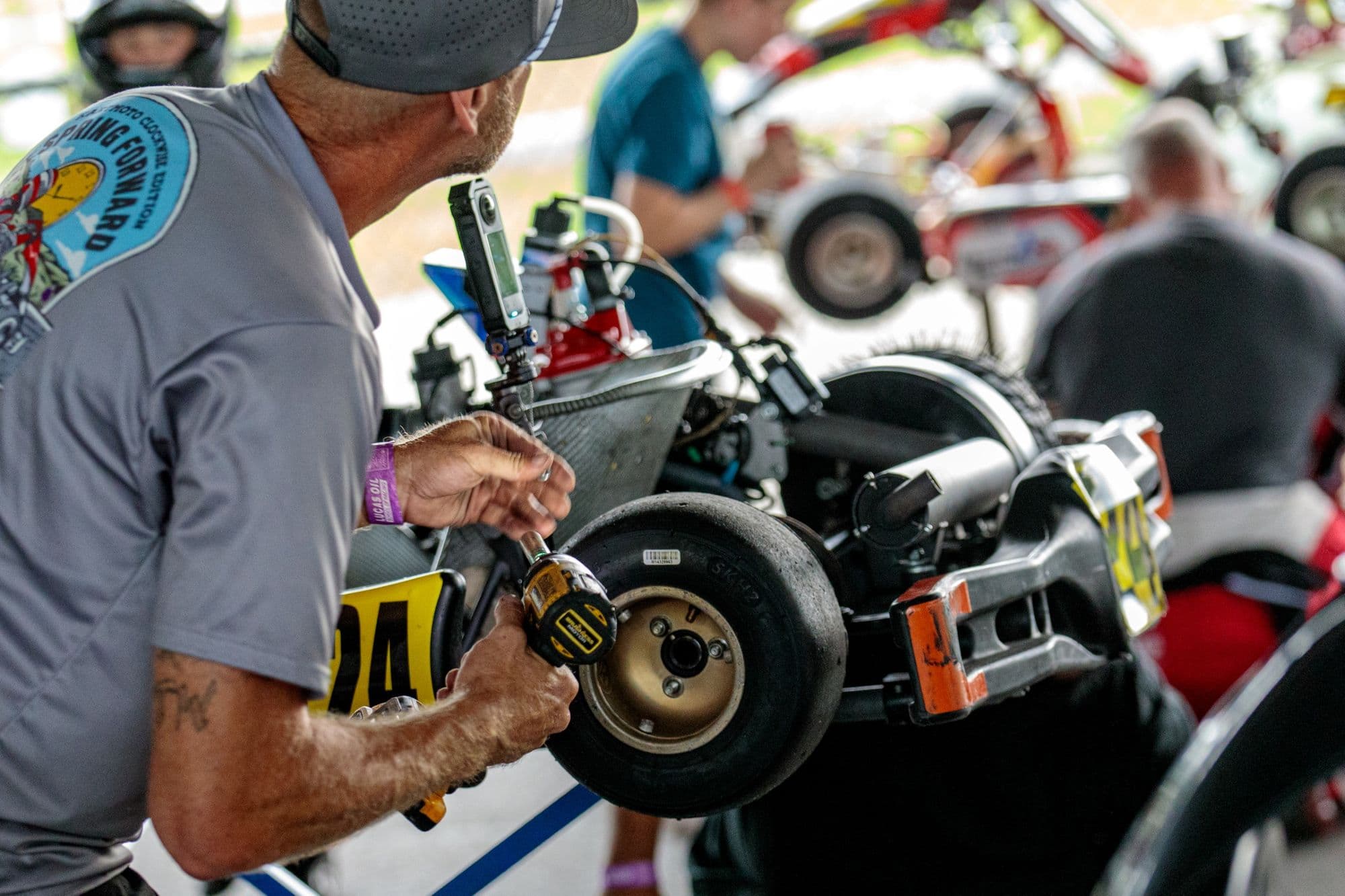 A mechanic works on a kart in the GCKI Katy paddock.